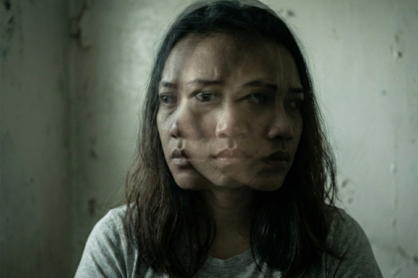 A cinematic double-exposure of a Filipino woman’s face, showing multiple expressions of confusion and distress simultaneously.